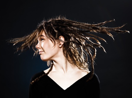 studio shot portraits of a young blond caucasian woman with dreadlocks on black backgroundの写真素材