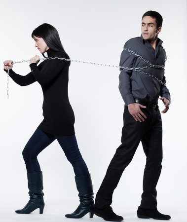 woman binding his man with a chain on white background