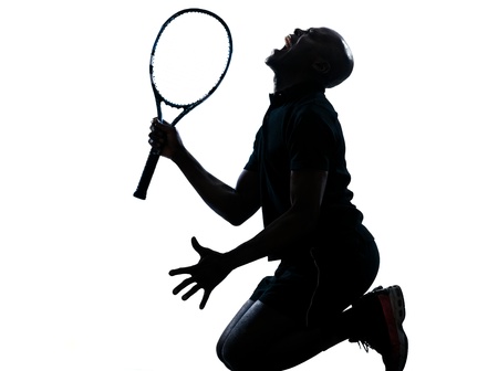 on man african afro american playing tennis player kneeling screaming on studio isolated on white backgroundの写真素材