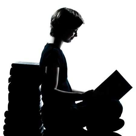 one caucasian young teenager silhouette boy or girl reading full length in studio cut out isolated on white backgroundの写真素材