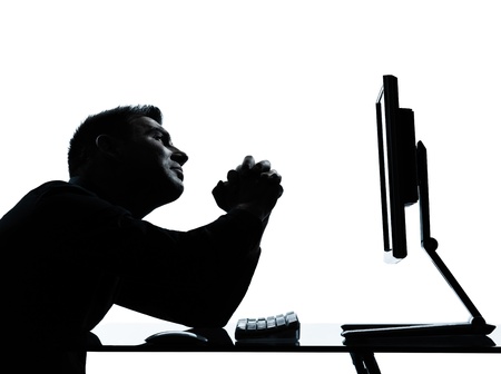 one caucasian business man computer computing begging despair silhouette in studio isolated on white backgroundの写真素材