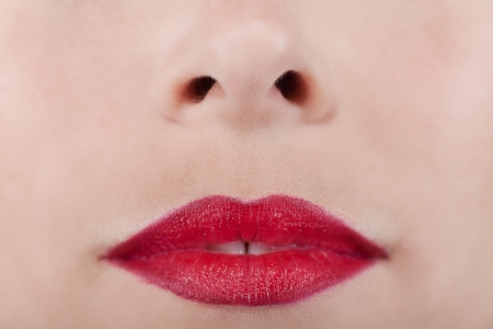 Background of a woman's nose and red lipsの写真素材