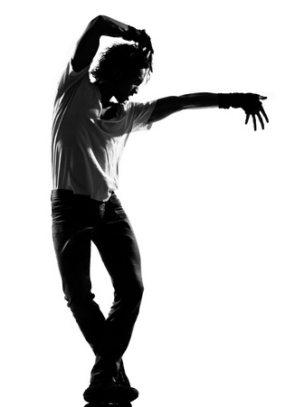 full length silhouette of a young man dancer dancing funky hip hop r&b on  isolated  studio white backgroundの写真素材