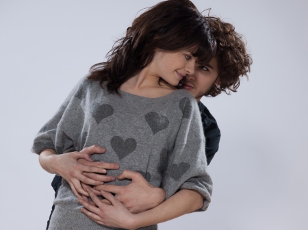 beuatiful caucasian young couple wearing a sweater with hearts on itの写真素材