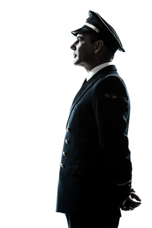 one caucasian man in airline pilot uniform silhouette in studio isolated on white backgroundの写真素材
