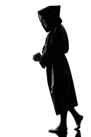 one caucasian man priest praying silhouette in studio isolated on white backgroundの写真素材