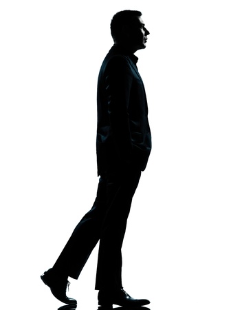 one caucasian business man walking silhouette Full length in studio isolated on white backgroundの写真素材