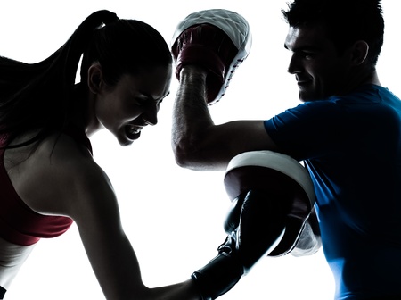 personal trainer man coach and woman exercising boxing silhouette  studio isolated on white backgroundの写真素材