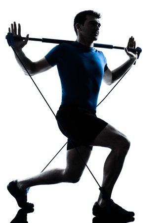 one caucasian man exercising gymstick workout fitness in silhouette studio  isolated on white backgroundの写真素材