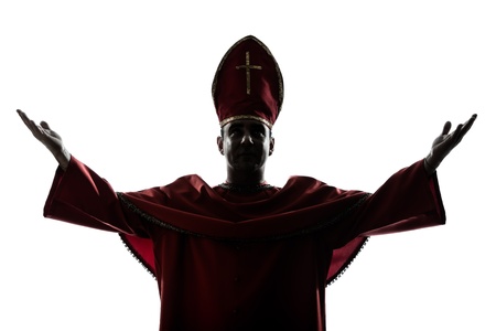one man cardinal bishop silhouette saluting blessing in studio isolated on white backgroundの写真素材