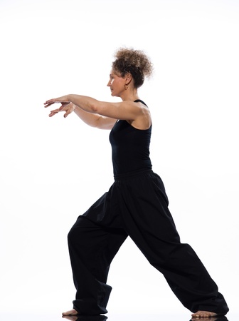 mature woman praticing tai chi chuan in studio on isolated white backgroundの写真素材