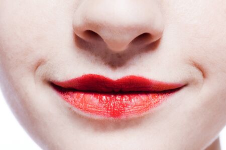 young beautiful caucasian woman playing with heart drawing on lipsの写真素材