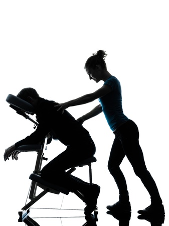 one man and woman perfoming chair back massage in silhouette studio on white background one man and woman perfoming chair back massage in silhouette studio on white background