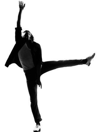 full length silhouette of a young man dancer dancing funky hip hop r&b on  isolated  studio white backgroundの写真素材