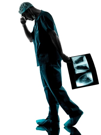 one caucasian man doctor surgeon radiologist medical worker silhouette isolated on white backgroundの写真素材