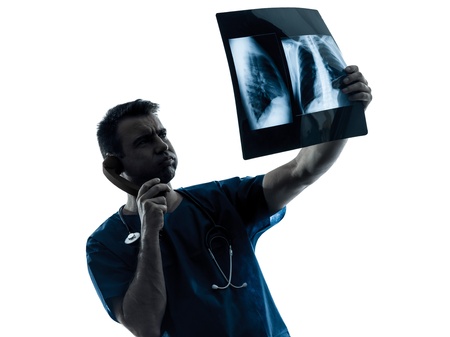 one caucasian man doctor surgeon radiologist medical examaning lung torso  x-ray image silhouette...