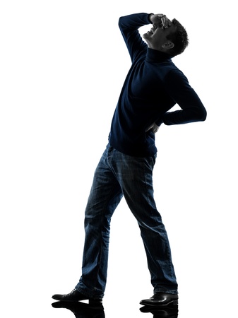 one causasian man full length in silhouette studio isolated on white backgroundの写真素材