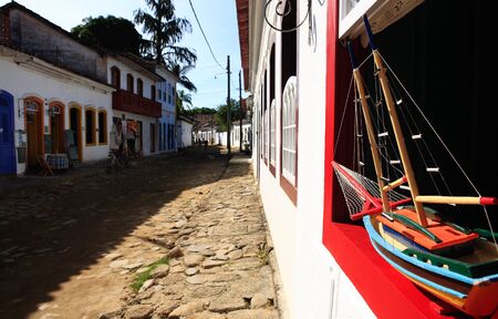 boat model at a window of the beautiful portuguese colonial typical town of parati in rio de janeiro state brazilの写真素材