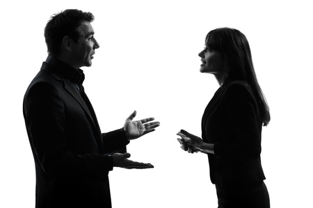 one caucasian couple business woman man in silhouette studio isolated on white backgroundの写真素材