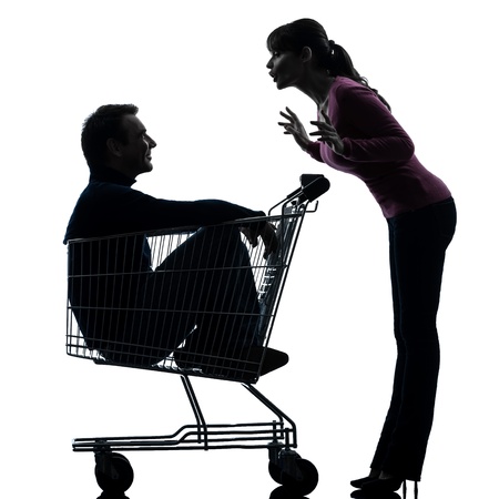 one caucasian couple woman  with man sitting in shopping cart   in silhouette studio isolated on white backgroundの写真素材