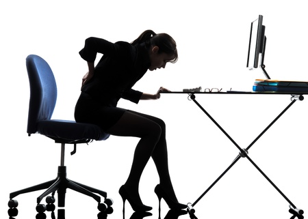 one caucasian business woman sitting backache pain in silhouette studio isolated on white backgroundの写真素材