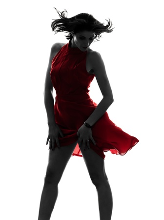 one caucasian fashion model sexy woman in red dress in silhouette studio isolated on white backgroundの写真素材