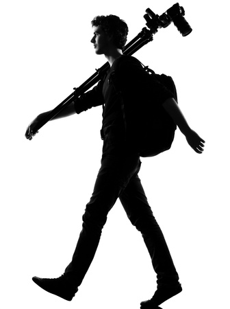 young man photographer silhouette in studio isolated on white backgroundの写真素材