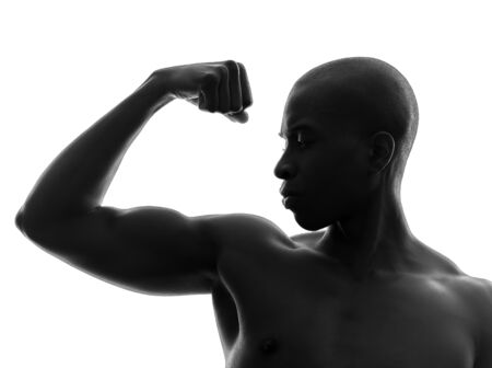 one african  black man flexing muscle  in silhouette studio on white backgroundの写真素材