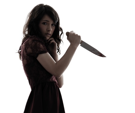 one caucasian strange young woman killer holding  bloody knife in silhouette white backgroundの写真素材