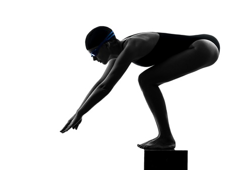 one caucasian woman competition swimmer on starting in silhouette studio isolated on white backgroundの写真素材