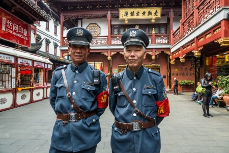 Shanghai, China - April 7, 2013: two tourist policemen posing and smiling in Fang Bang Zhong Lu old city  at the city of Shanghai in China on april 7th, 2013のeditorial素材
