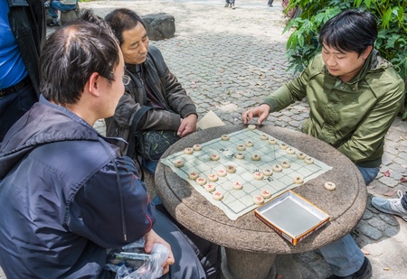 Shanghai, China - April 7, 2013: people playing chinese chess in people's park  at the city of Shanghai in China on april 7th, 2013のeditorial素材