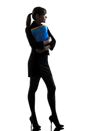 one business woman hold g folders files stand g  silhouette studio isolated on white backgroundの写真素材