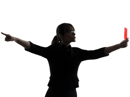 one business woman showing red card  silhouette studio isolated on white backgroundの写真素材