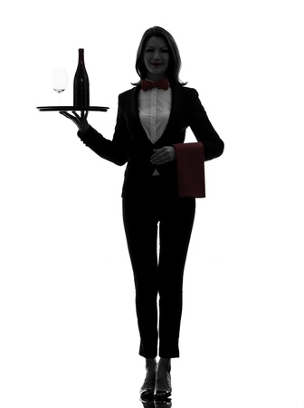 one caucasian woman waiter butler serving red wine in silhouette  on white backgroundの写真素材