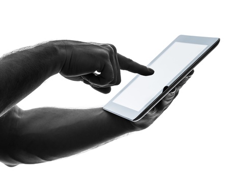 close up hands man touchscreen  one caucasian man touchscreen digital tablet   in silhouette on...