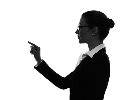 one caucasian business woman touching copy sapce in silhouette  on white backgroundの写真素材