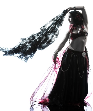 one arabic woman belly dancer dancing silhouette studio isolated on white backgroundの写真素材