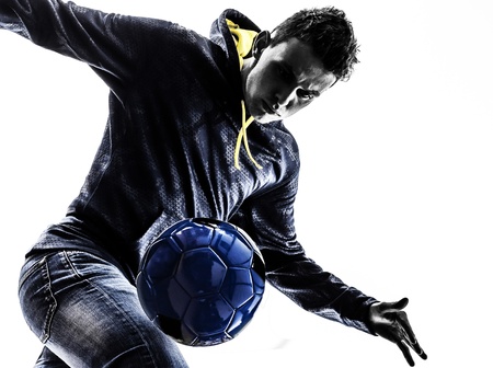 one caucasian young man soccer frestyler player in silhouette on white background one caucasian young man soccer frestyler player in silhouette on white background