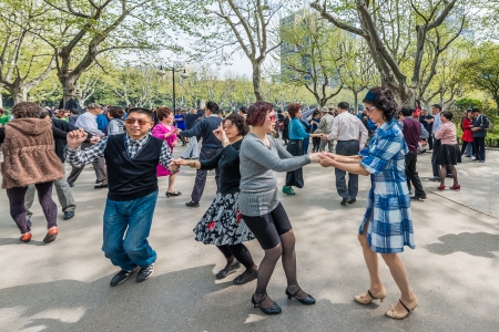 Shanghai, China - April 7, 2013: group of people dancing in fuxing park at the city of Shanghai in China on april 7th, 2013のeditorial素材