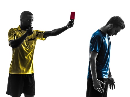 two men soccer player and referee showing red card in silhouette  on white background