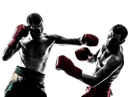 two caucasian  men exercising thai boxing in silhouette studio  on white backgroundの写真素材