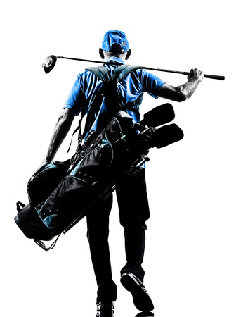 one man golfer golfing golf bag walking  in silhouette studio isolated on white backgroundの写真素材