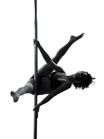 one caucasian woman pole dancer dancing in silhouette studio isolated on white backgroundの写真素材