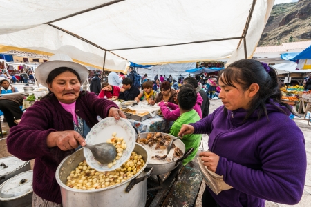 Pisac, Peru - July 14, 2013: Women cooking at Pisac market in the peruvian Andes at Pisac Peru on july 14th 2013のeditorial素材