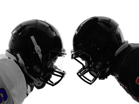 two american football players face to face in silhouette shadow on white backgroundの写真素材
