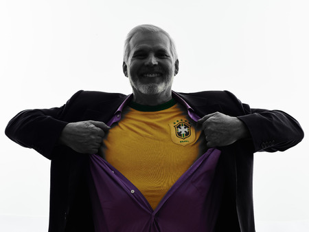 One Caucasian Senior Brazilian Supporter Fan Man Silhouette Studio Isolated White Backgroundの写真素材
