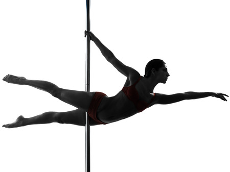 one caucasian woman pole dancer dancing in silhouette studio isolated on white backgroundの写真素材