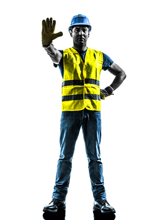 one  construction worker stop gesture with safety vest silhouette isolated in white backgroundの写真素材