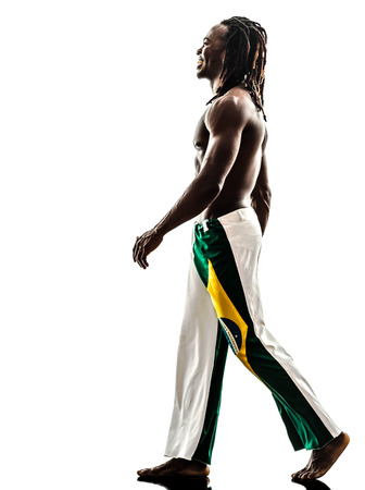 one Brazilian black man walking smiling on white backgroundの写真素材